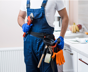 Man standing with all plumbing equipment