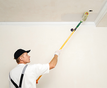 Man painting roof