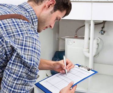 Man writing out a Certificate of Compliance
