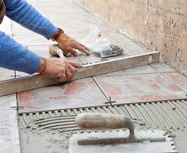 Man Tiling a Floor